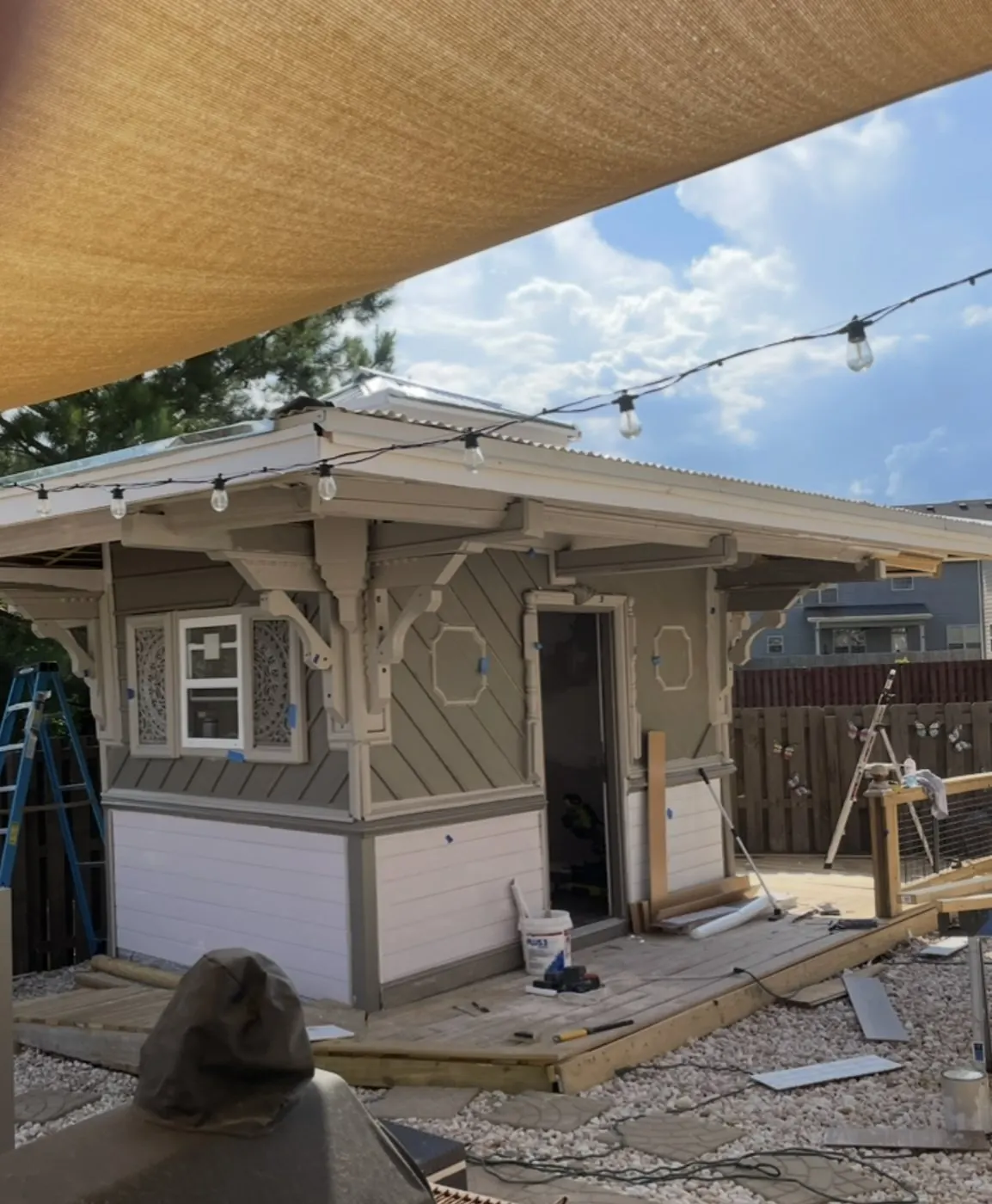 Backyard studio exterior with octagon trim panels and carved corner brackets