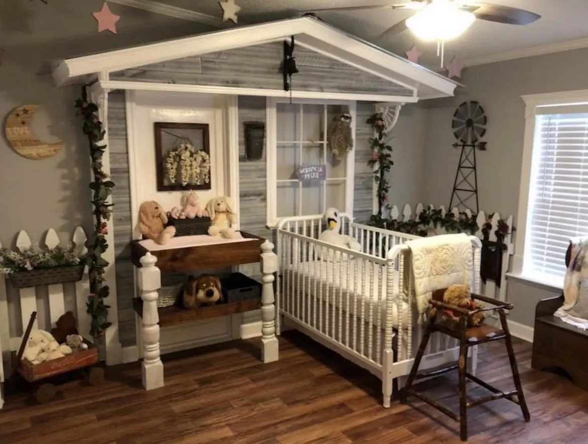 Interior wall built out as a farmhouse porch front, with siding, posts and a gable roof