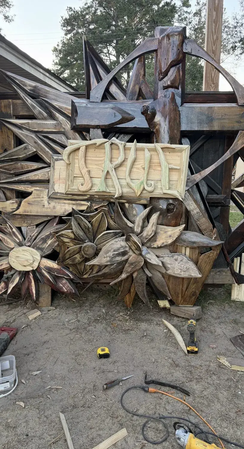 Group of carved wooden florals showing scale
