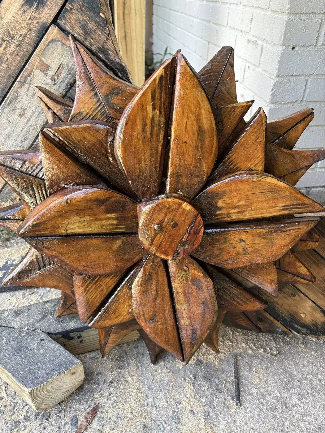 Close view of a carved wooden flower showing layered petals