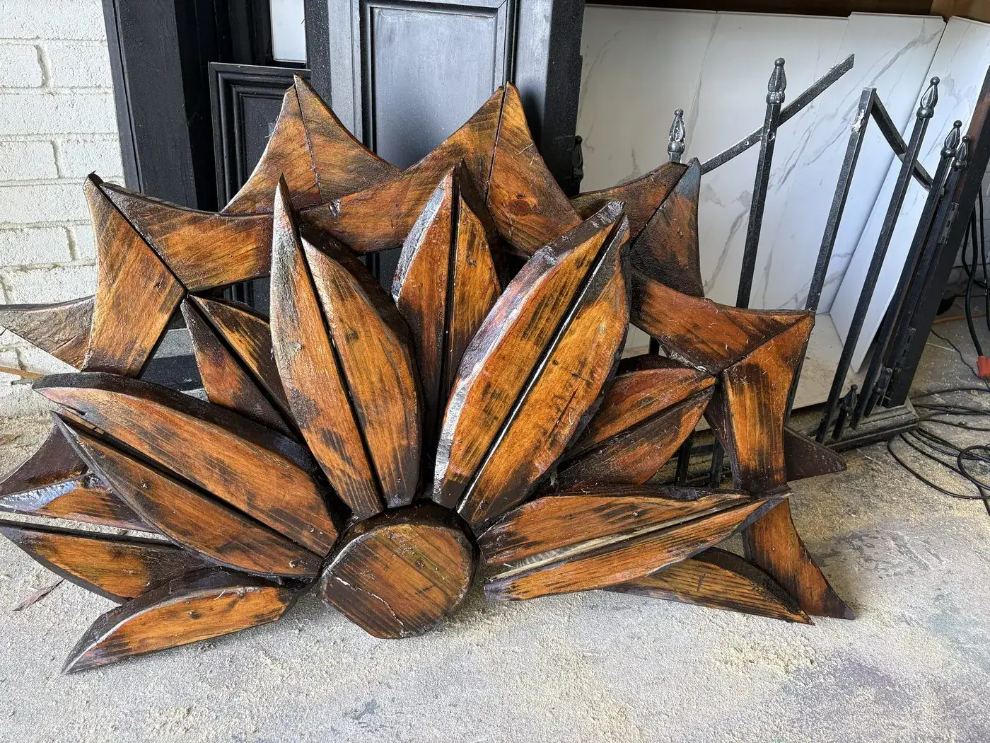 Group of carved wooden flowers staged outside the shop