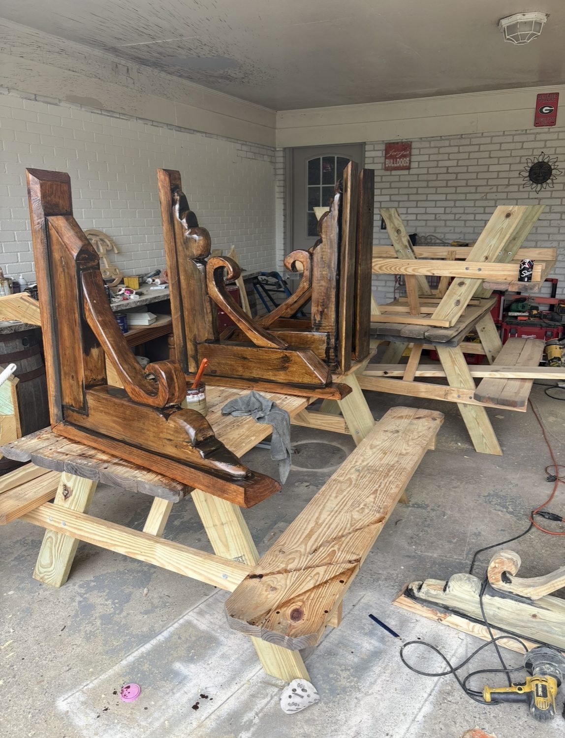 Carved cypress corbels and scroll brackets staged in the Severed Roots shop