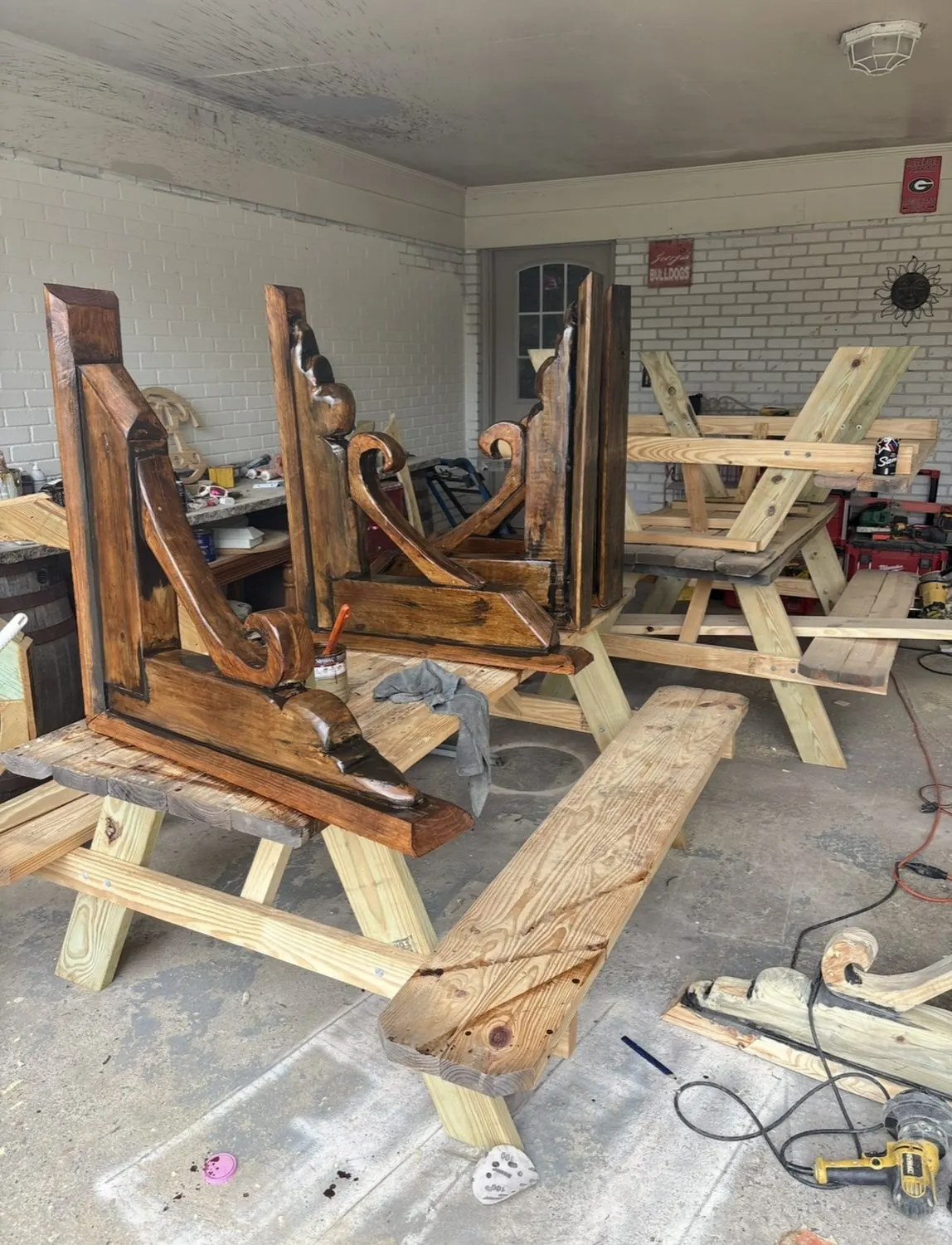 Carved corbels and scroll brackets staged in the Severed Roots shop