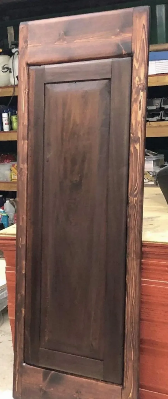 The same paneled door after restoration and stain