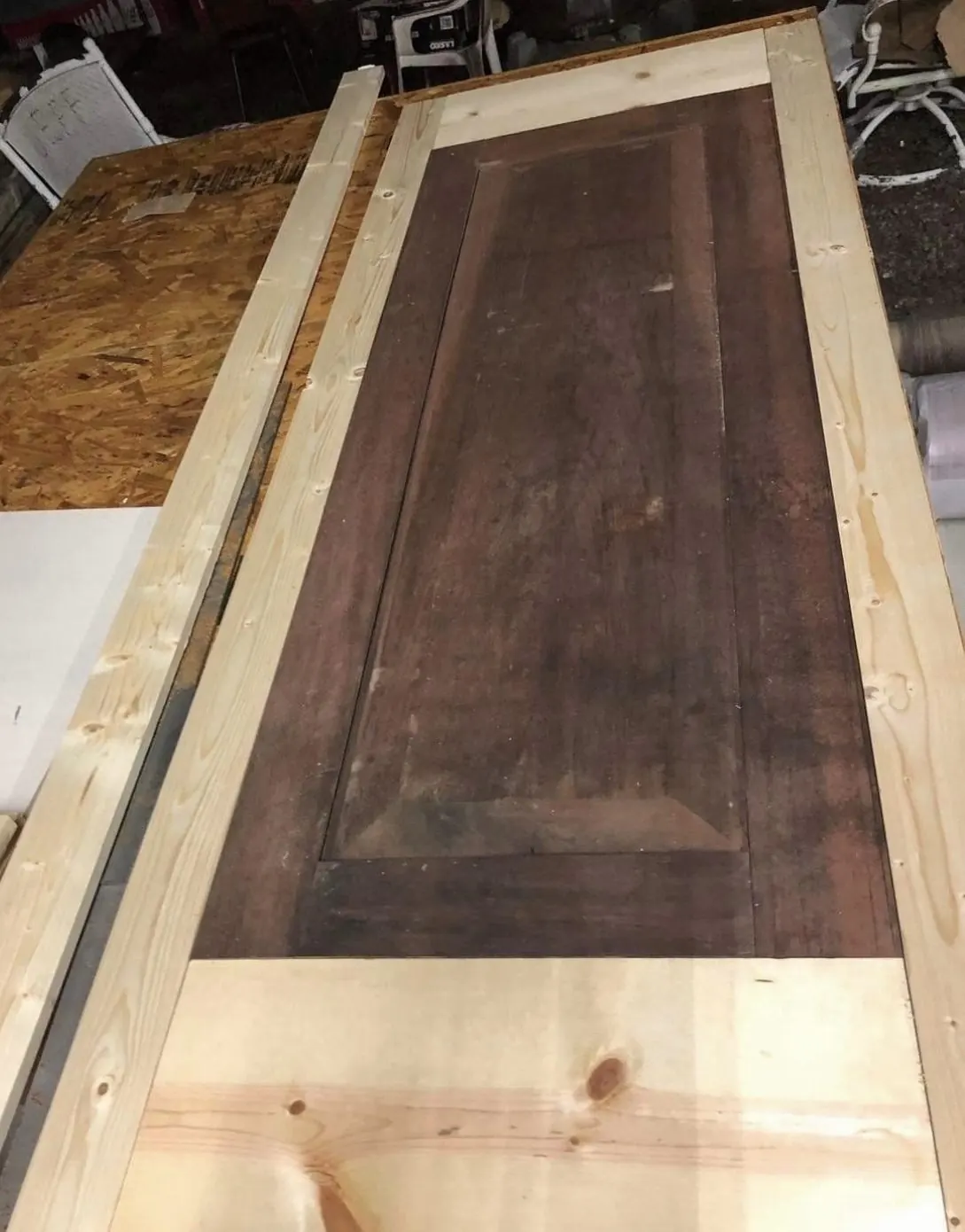 Weathered paneled door before restoration