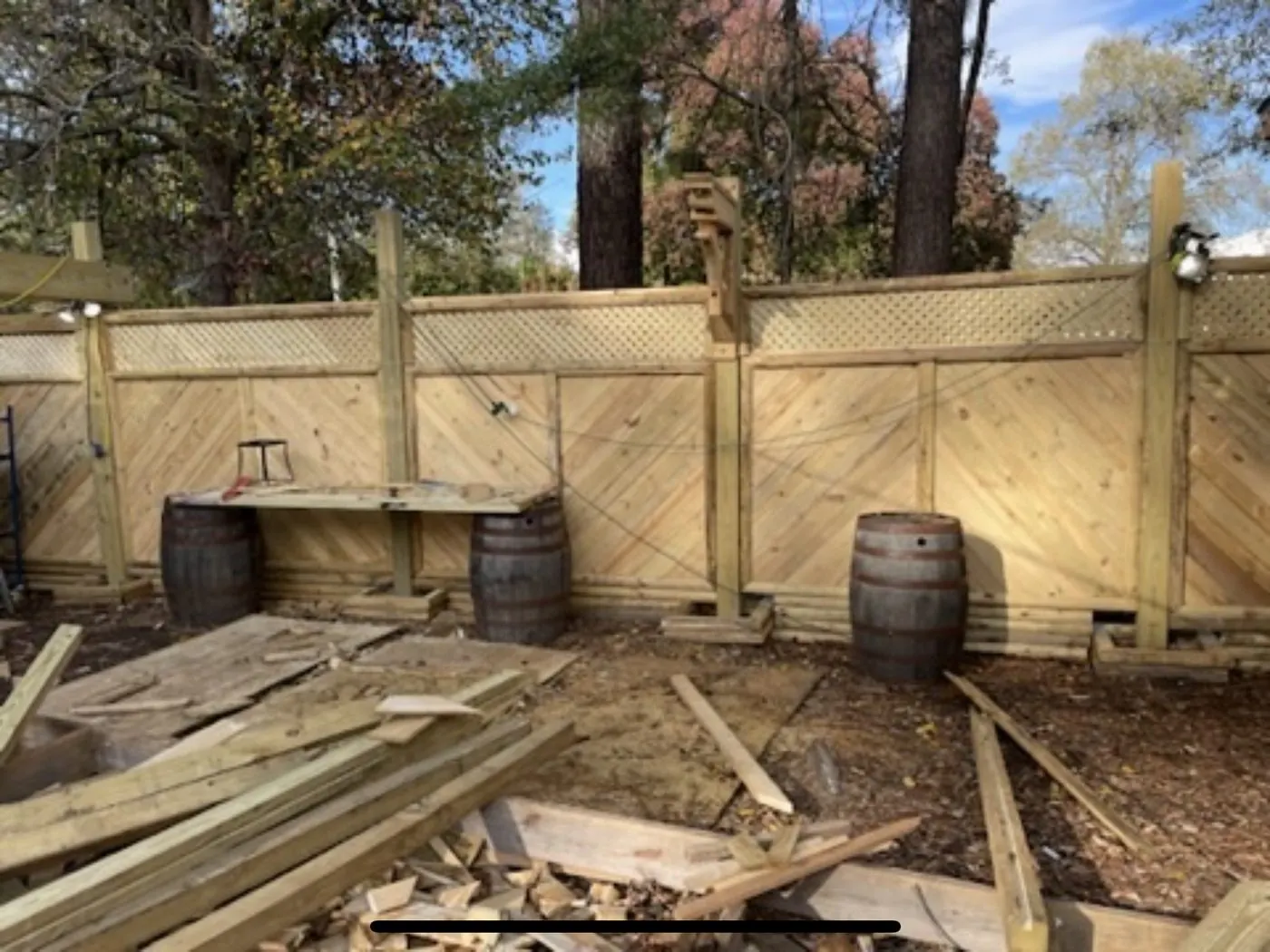 Chevron privacy wall with a bar top built off whiskey barrels