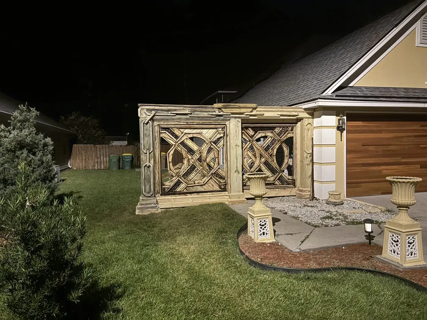 Gate at night with header molding and carved chain columns added