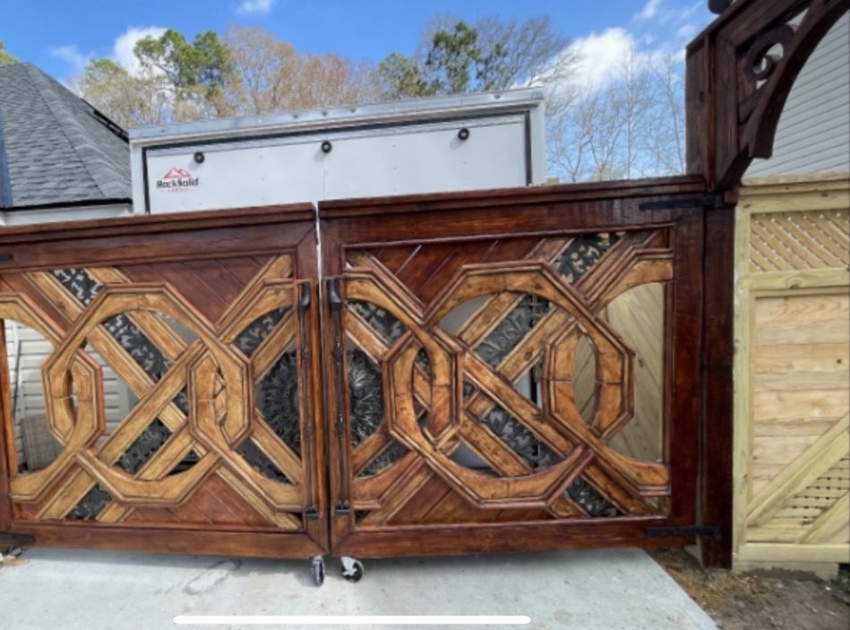 Angled view of the monogram gate showing depth of the layered lattice