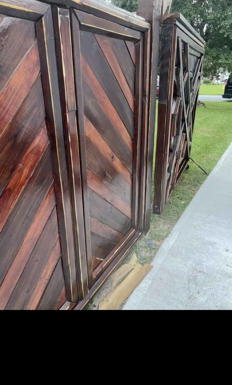 Deep red stained chevron gates standing at the curb