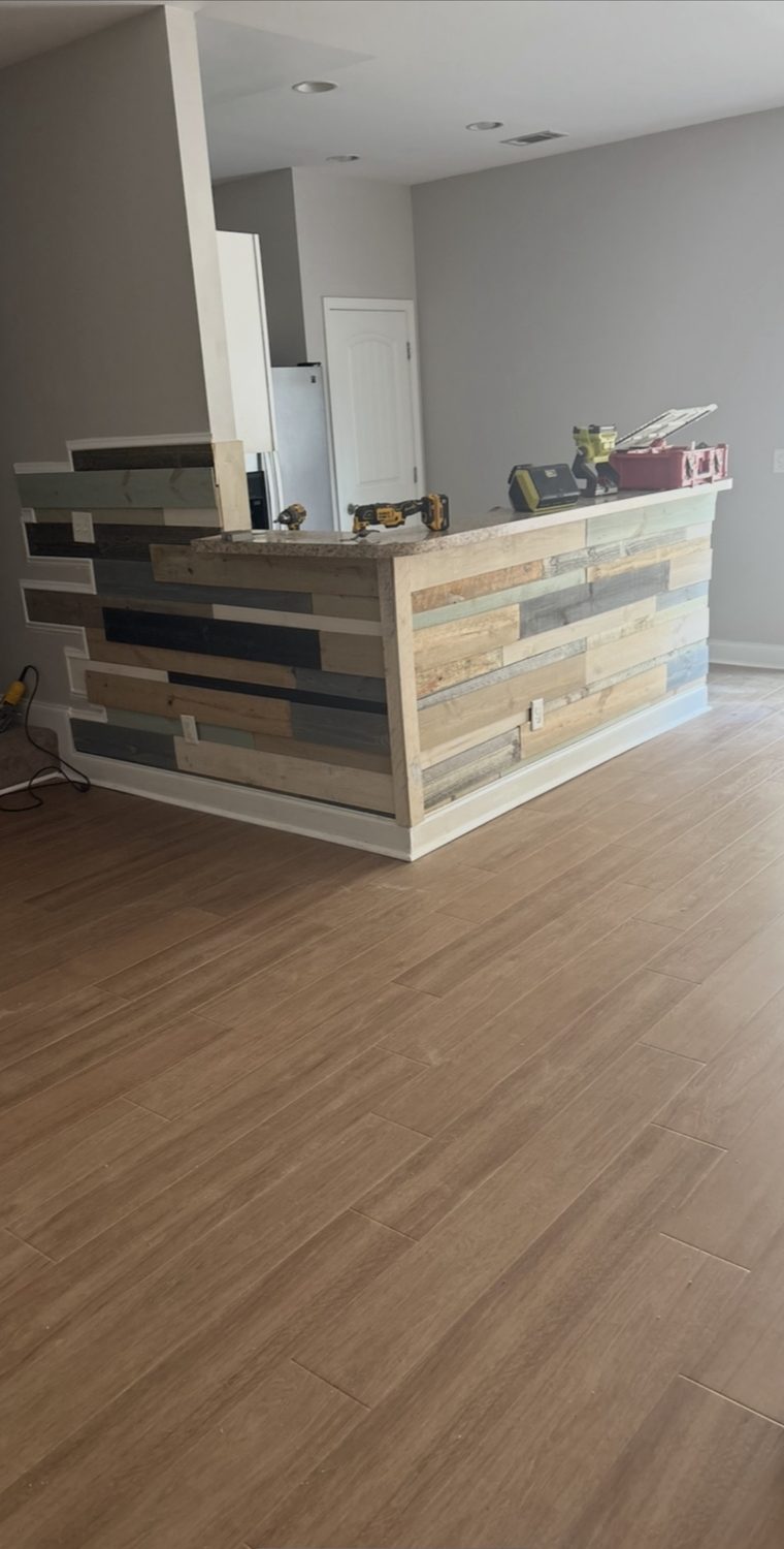 Kitchen island clad in reclaimed multi-color planks