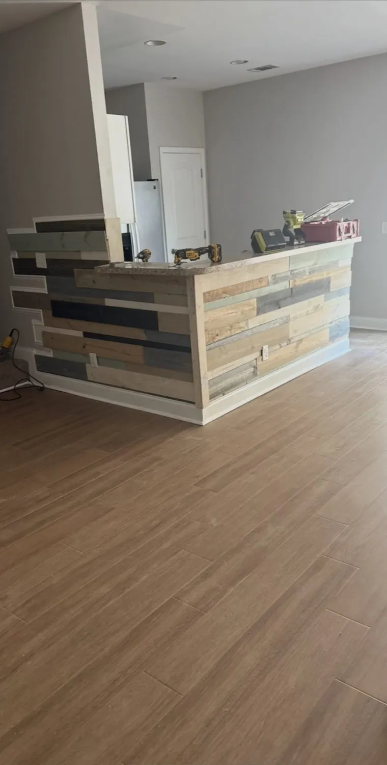 Kitchen island clad in multi-color reclaimed planks