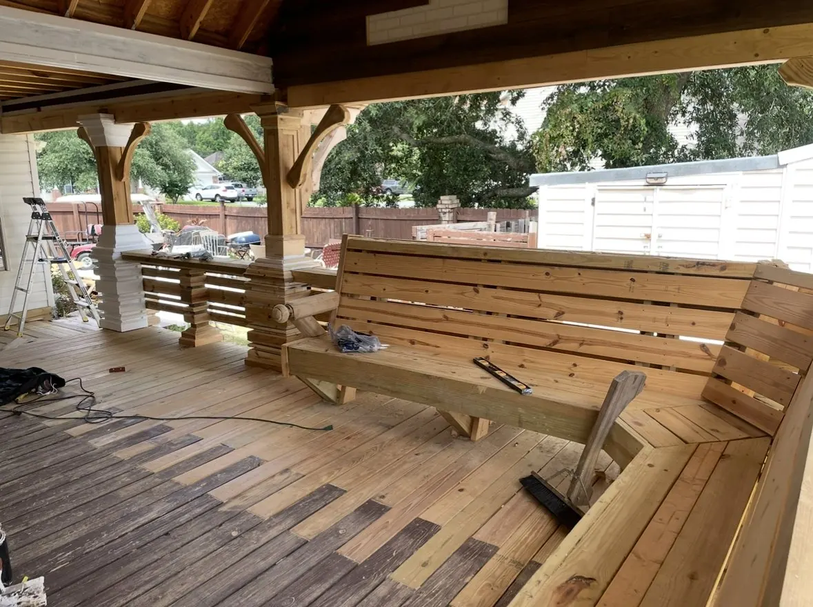 Covered pavilion with built-in bench seating, slat rail and stepped post bases