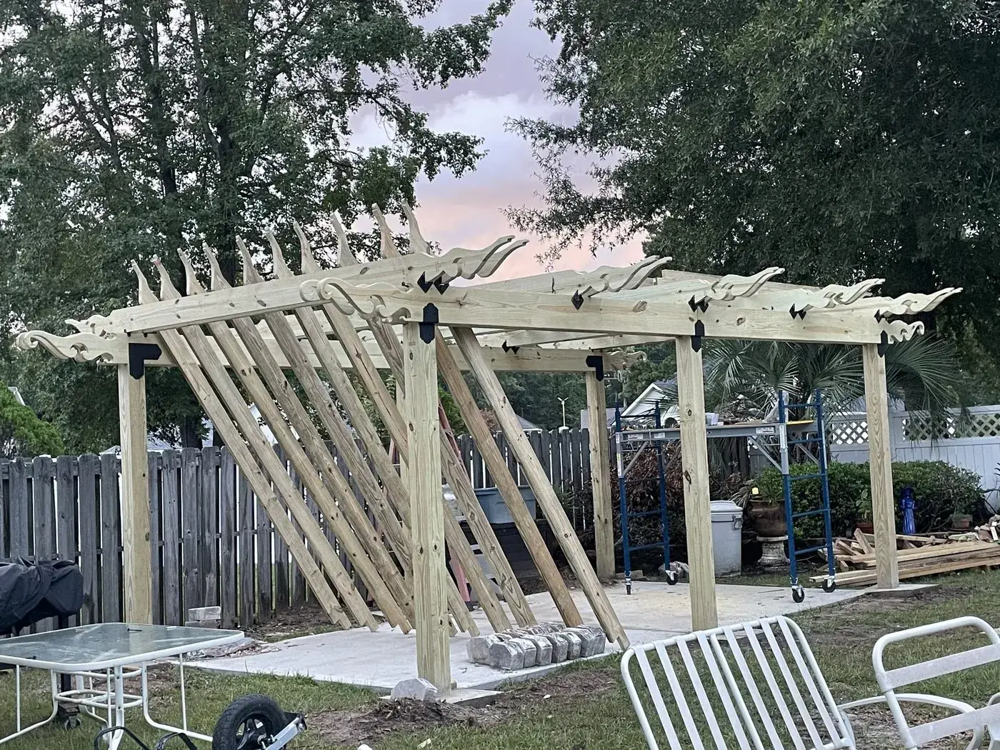 The same frame at dusk with the carved header scrolls in place