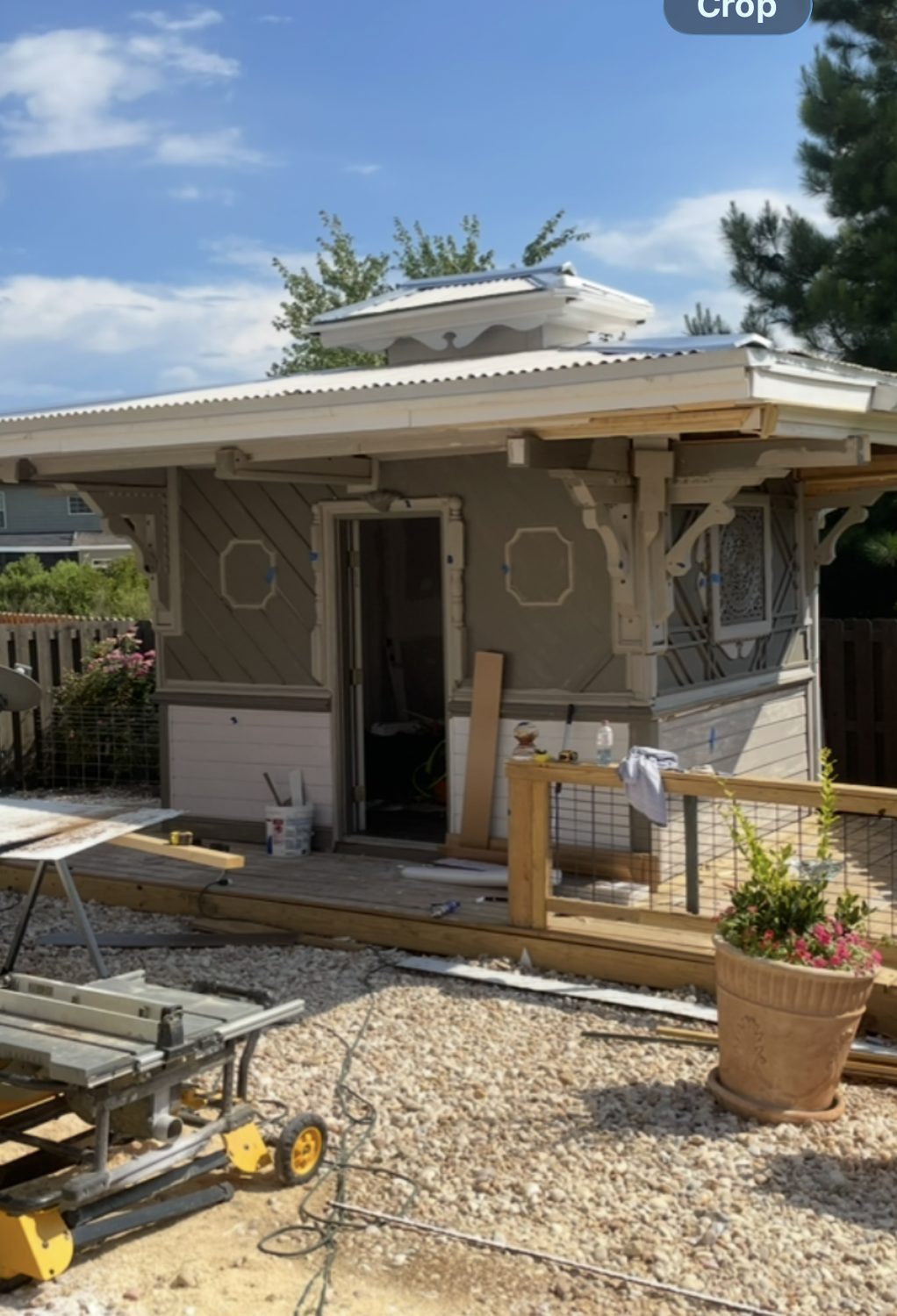 Outbuilding with carved window crowns and lattice corner panels