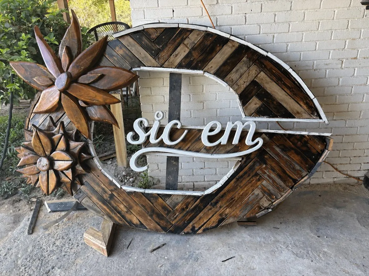 Large wooden G sign with sic em script and carved florals