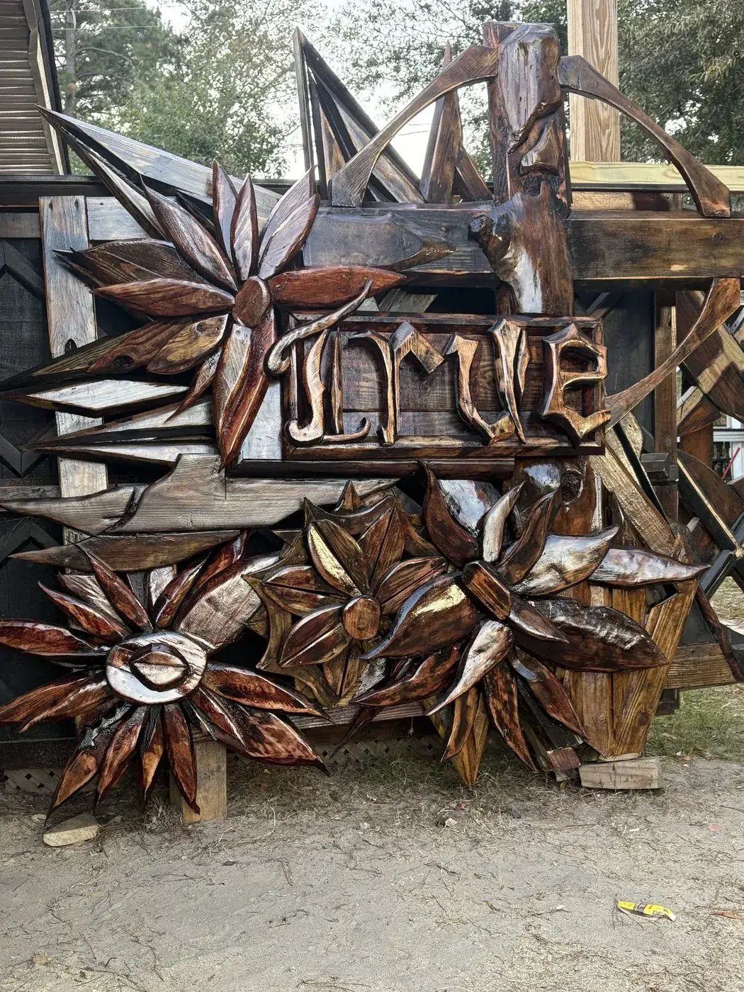 Carved JLM monogram sign with wooden florals and a torched finish