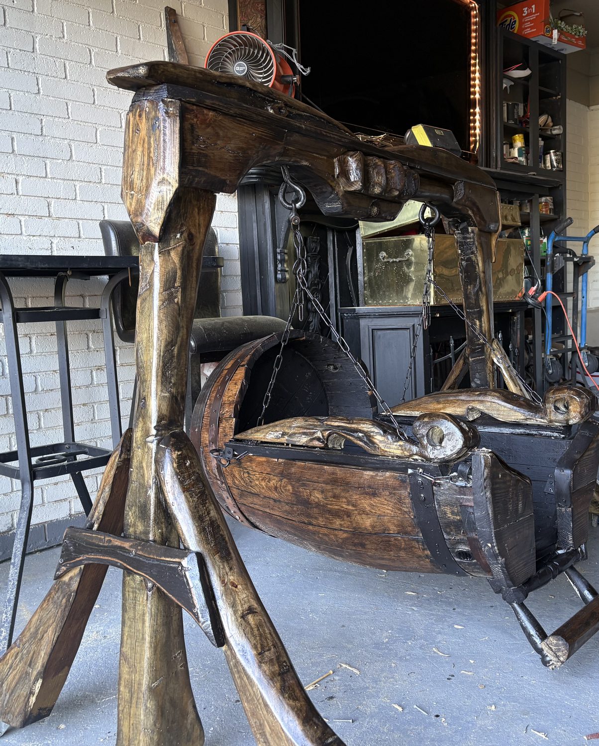 Hand carved barrel cradle swing on a timber stand
