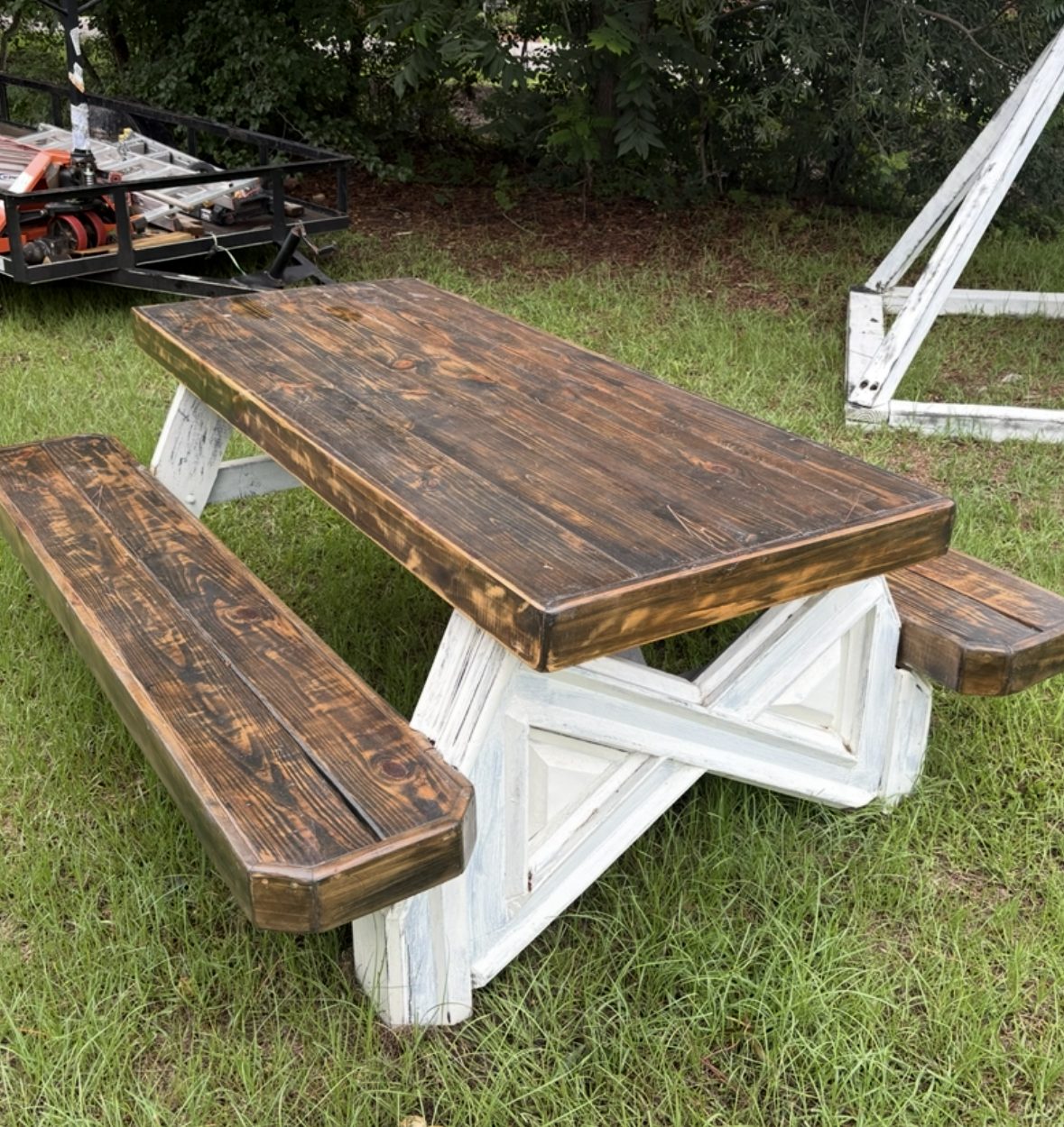 Picnic table with stained top and distressed white base